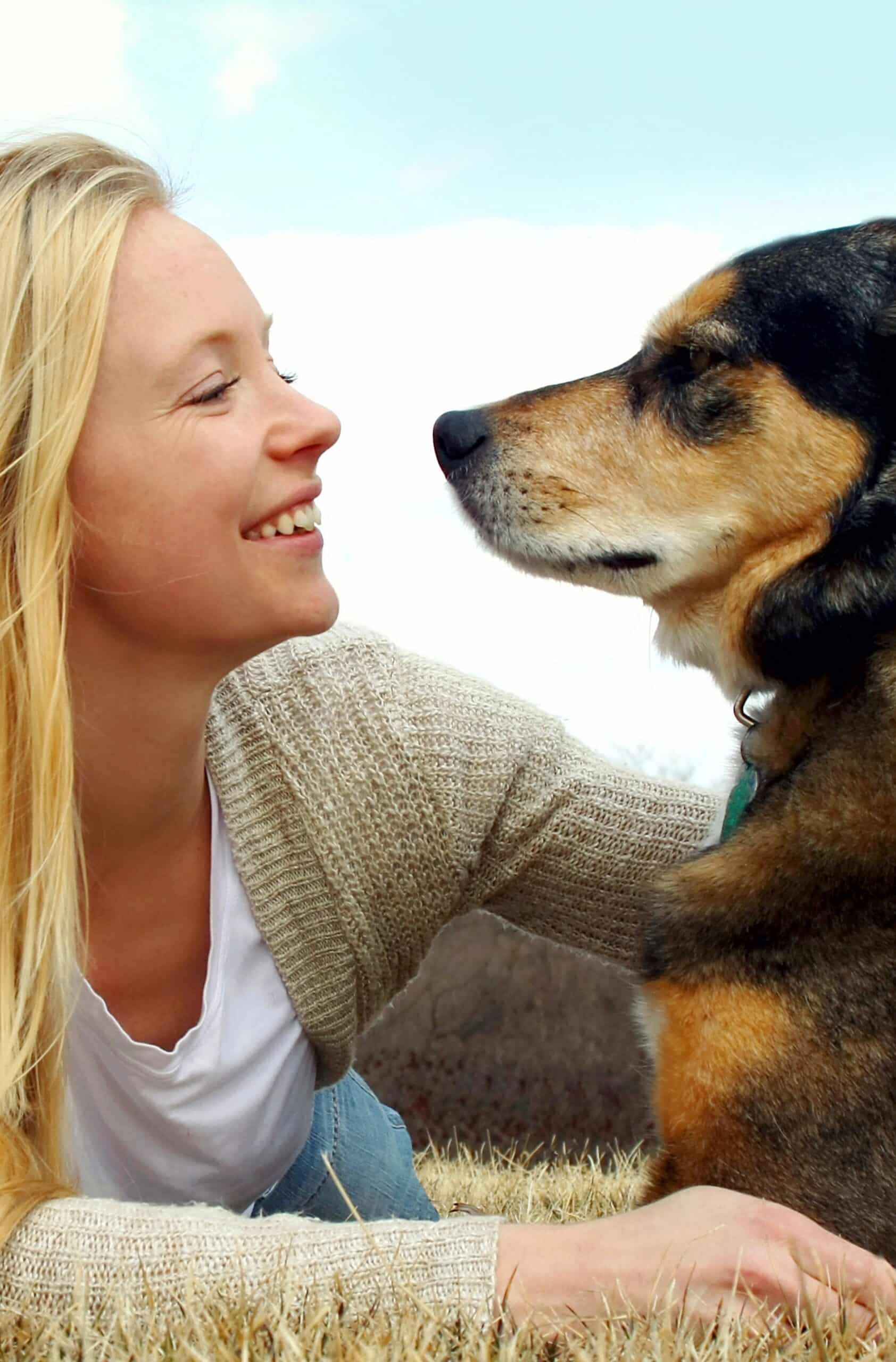 A woman smiling with a dog